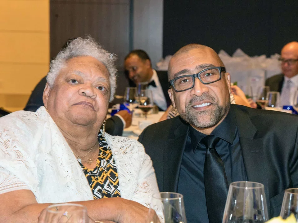 Two scholars sitting next to each other at awards dinner.